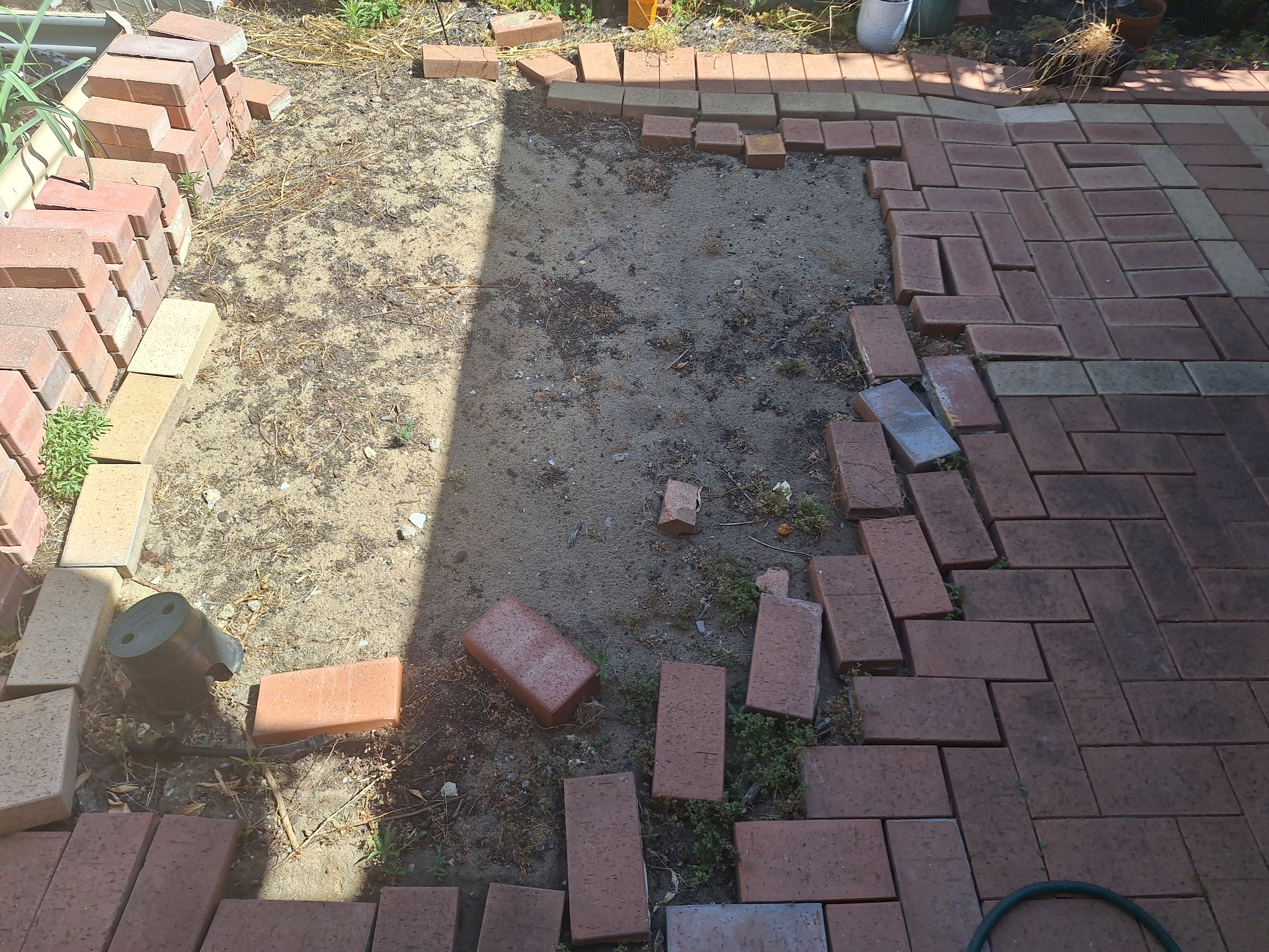 To expand the patio we need to find matching bricks, and learn how to pave. Those bricks on the left do not REMOTELY match :(