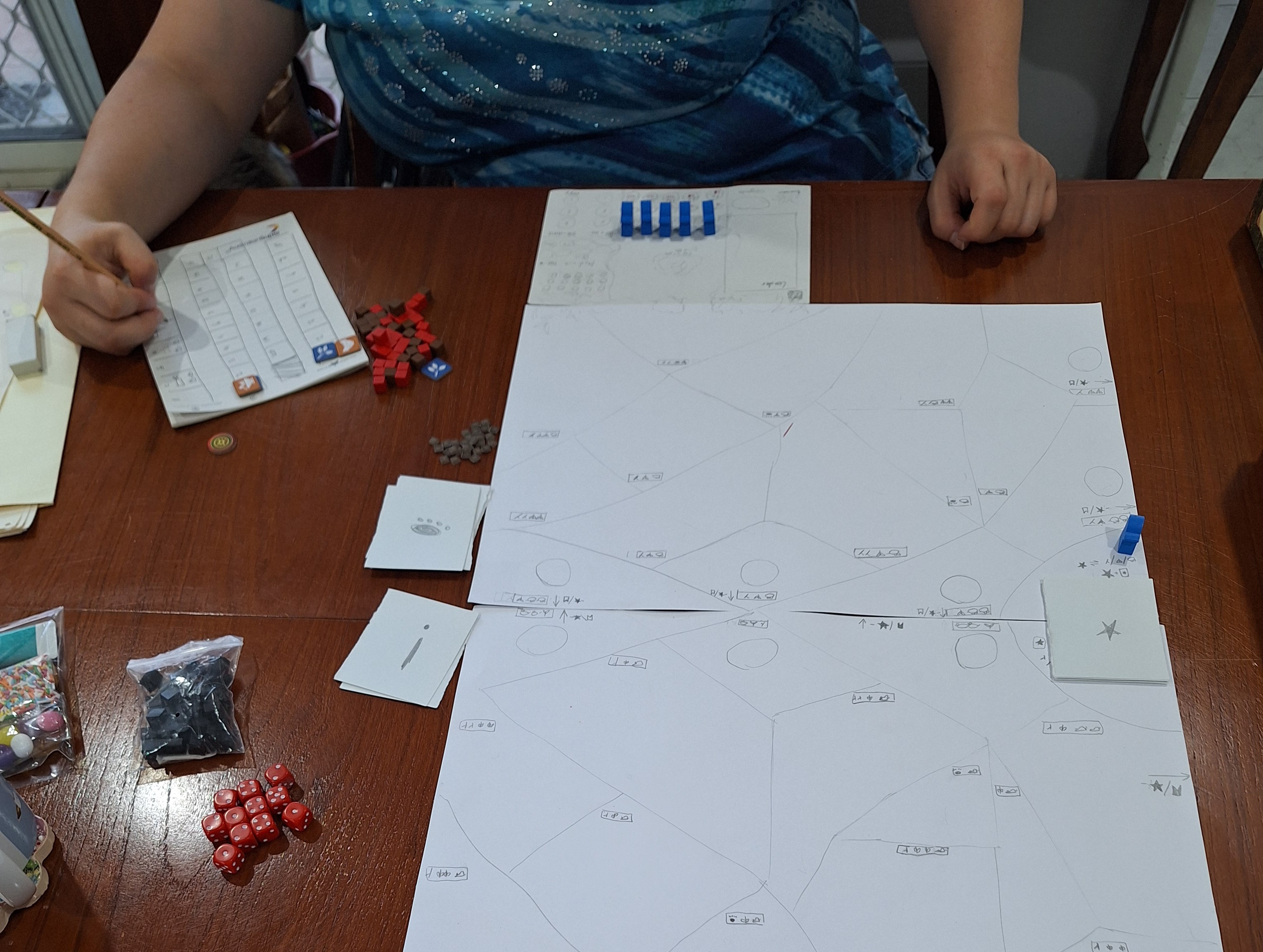 This 'working' prototype of our Warriors game borrowed meeples from Root, resources from Champions of Midgard, and pieces from Scythe and Ark Nova
